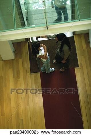Man and woman standing facing each other near door, view from above. View Large Photo Image Stock Photography - Man and woman standing facing each other near door, view from above.. Fotosearch