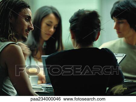Man looking at woman in work group. View Large Photo Image Stock Photograph - Man looking at woman in work group.. Fotosearch