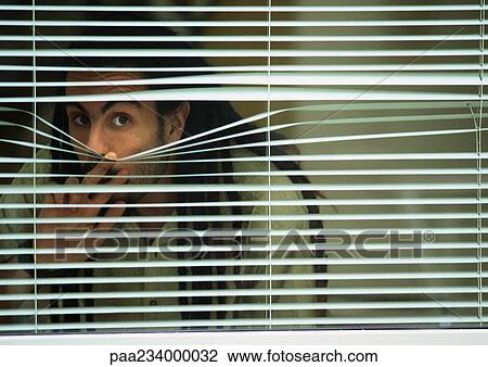 Man looking though blinds. View Large Photo Image Stock Image - Man looking though blinds.. Fotosearch