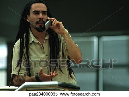 Man talking on cell phone, leaning against rail. View Large Photo Image Stock Photography - Man talking on cell phone, leaning against rail.. Fotosearch
