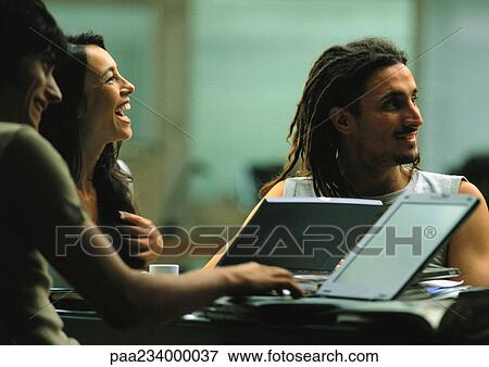 Men and woman working and laughing together. View Large Photo Image Stock Photo - Men and woman working and laughing together.. Fotosearch