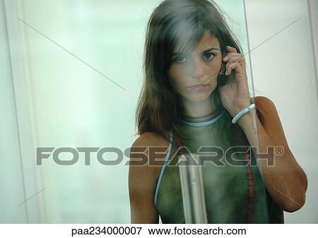 Woman on cell phone, view through glass. View Large Photo Image Stock Photo - Woman on cell phone, view through glass.. Fotosearch