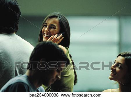 Woman talking on cellphone in group of people. View Large Photo Image Stock Photo - Woman talking on cellphone in group of people.. Fotosearch