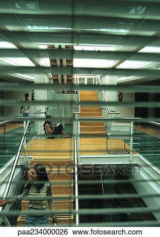 Woman walking down stairs, view through window blinds. View Large Photo Image Stock Photograph - Woman walking down stairs, view through window blinds.. Fotosearch