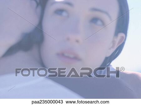 Stock Image - Man and woman hugging, close up. Fotosearch