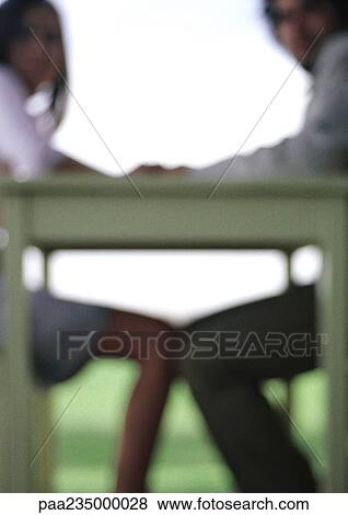 Man and woman sitting at table holding hands, blurred silhouette. View Large Photo Image Stock Photo - Man and woman sitting at table holding hands, blurred silhouette.. Fotosearch