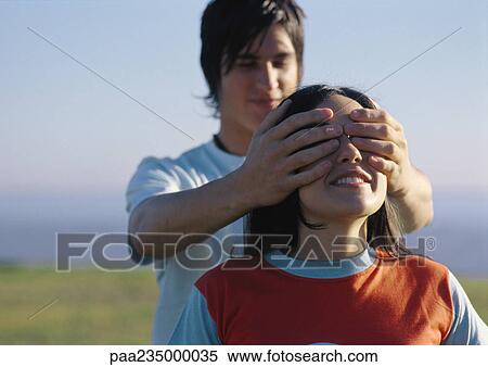 Man putting hands over woman's eyes. View Large Photo Image Stock Photography - Man putting hands over woman's eyes.. Fotosearch