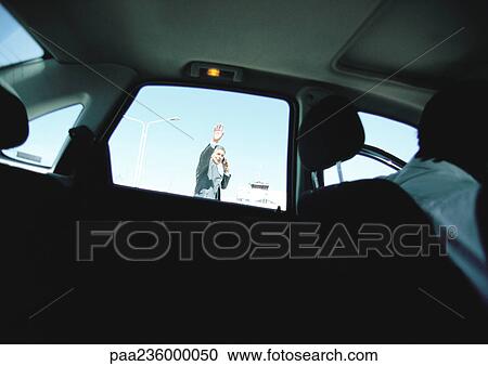 Businessman seen through taxi car window waving hand, hailing taxi car. View Large Photo Image Stock Image - Businessman seen through taxi car window waving hand, hailing taxi car.. Fotosearch