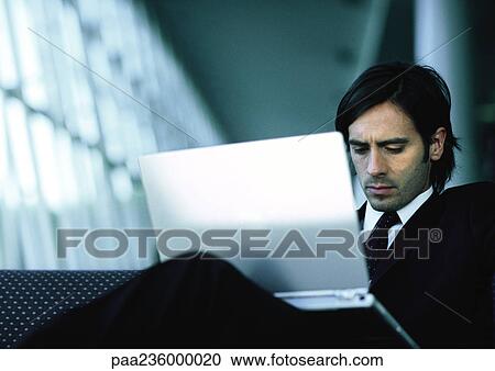 Businessman sitting, working on laptop. View Large Photo Image Stock Image - Businessman sitting, working on laptop.. Fotosearch