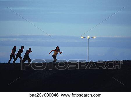 Friends running at sunset. View Large Photo Image Stock Photograph - Friends running at sunset.. Fotosearch