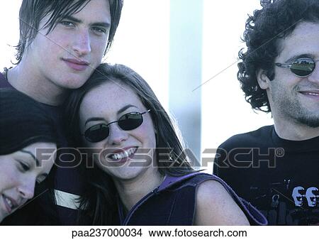 Friends standing together, close-up. View Large Photo Image Picture - Friends standing together, close-up.. Fotosearch