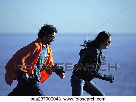 Man and woman running near water. View Large Photo Image Stock Image - Man and woman running near water.. Fotosearch