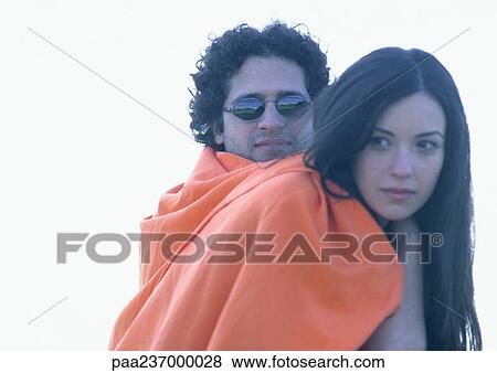 Man and woman wrapped in orange blanket, close-up. View Large Photo Image Stock Photo - Man and woman wrapped in orange blanket, close-up.. Fotosearch