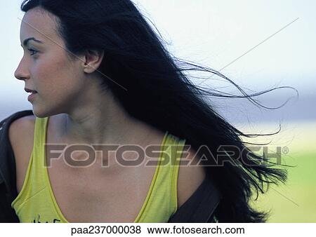 Woman looking to the side, wind in hair, close-up. View Large Photo Image Stock Photo - Woman looking to the side, wind in hair, close-up.. Fotosearch