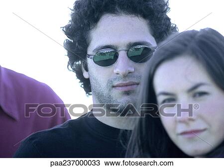 Woman next to man in sunglasses, close-up. View Large Photo Image Stock Image - Woman next to man in sunglasses, close-up.. Fotosearch