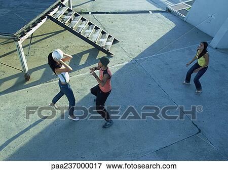 Stock Photo - Young people playing with ball, high angle view. Fotosearch