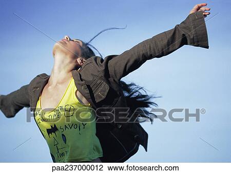 Young woman, arms stretched out, head back. View Large Photo Image Stock Image - Young woman, arms stretched out, head back.. Fotosearch