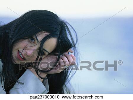 Young woman leaning on hands, close-up. View Large Photo Image Stock Image - Young woman leaning on hands, close-up.. Fotosearch