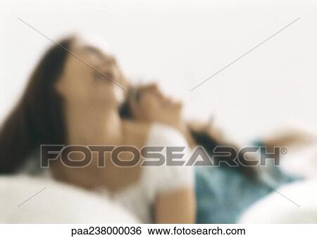 Stock Photograph - Two women laughing, blurred. Fotosearch