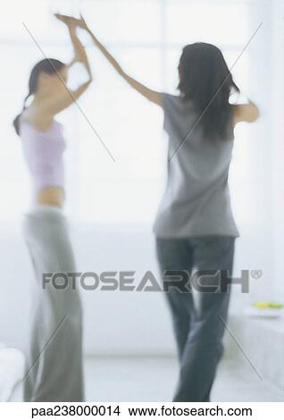 Two young women dancing, blurred View Large Photo Image Picture - Two young women dancing, blurred. Fotosearch