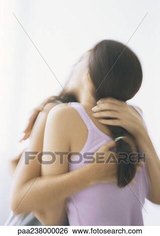 Two young women hugging, rear view View Large Photo Image Stock Photograph - Two young women hugging, rear view. Fotosearch