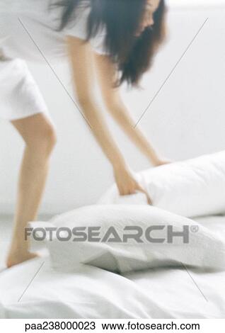 Woman bending over, picking up pillows, blurred View Large Photo Image Stock Image - Woman bending over, picking up pillows, blurred. Fotosearch