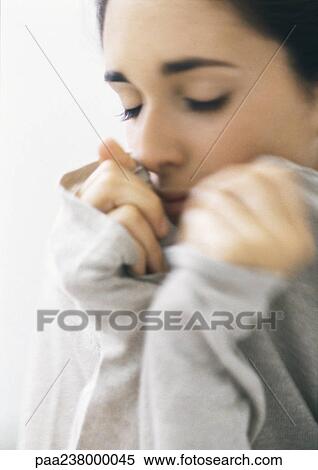 Woman holding sweater collar, eyes closed, close-up View Large Photo Image Stock Photography - Woman holding sweater collar, eyes closed, close-up. Fotosearch