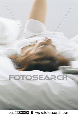 Woman lying on bed View Large Photo Image Stock Photo - Woman lying on bed. Fotosearch