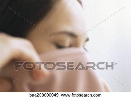 Stock Photo - Woman taking off shirt, close-up. Fotosearch