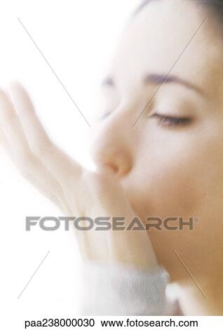 Woman with hand against mouth, close-up View Large Photo Image Stock Image - Woman with hand against mouth, close-up. Fotosearch