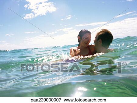Couple hugging in sea View Large Photo Image Stock Photo - Couple hugging in sea. Fotosearch