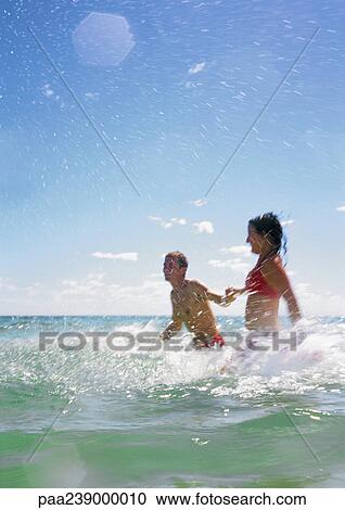 Couple standing in sea View Large Photo Image Stock Image - Couple standing in sea. Fotosearch
