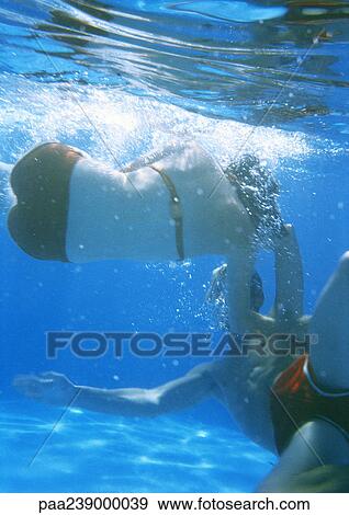 Stock Photo - Couple swimming underwater. Fotosearch
