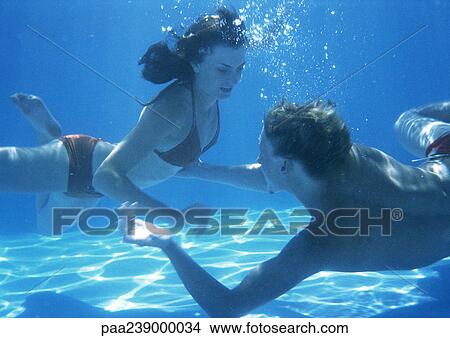Man and woman swimming underwater View Large Photo Image Picture - Man and woman swimming underwater. Fotosearch