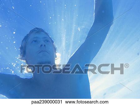 Man underwater, low angle view View Large Photo Image Stock Image - Man underwater, low angle view. Fotosearch
