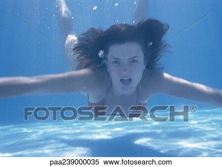 Woman swimming underwater, portrait View Large Photo Image Stock Photography - Woman swimming underwater, portrait. Fotosearch