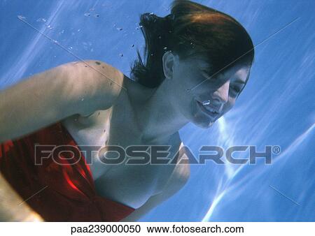 Woman swimming underwater View Large Photo Image Stock Image - Woman swimming underwater. Fotosearch