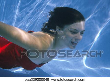 Woman swimming underwater View Large Photo Image Stock Photo - Woman swimming underwater. Fotosearch