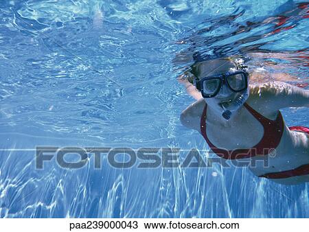 Woman swimming underwater with mask View Large Photo Image Stock Image - Woman swimming underwater with mask. Fotosearch