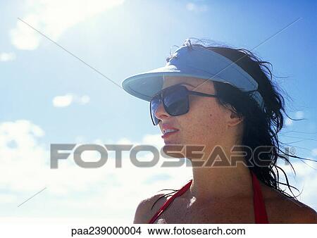 Woman wearing sunglasses, outside, close-up View Large Photo Image Picture - Woman wearing sunglasses, outside, close-up. Fotosearch