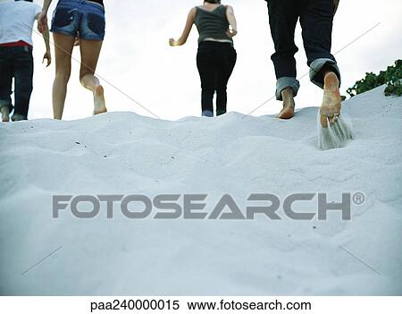 Four people running on sand, low section, rear view View Large Photo Image Stock Photography - Four people running on sand, low section, rear view. Fotosearch