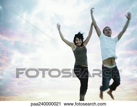 Man and woman jumping, portrait View Large Photo Image Stock Image - Man and woman jumping, portrait. Fotosearch