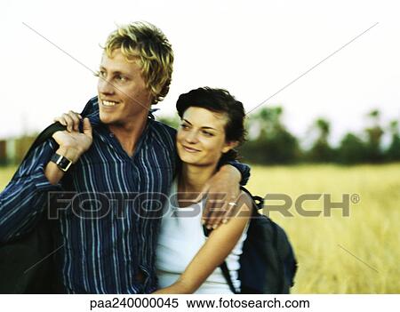 Man with arm around woman, smiling View Large Photo Image Stock Photography - Man with arm around woman, smiling. Fotosearch