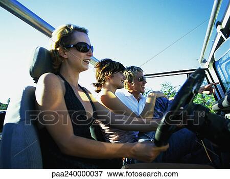 Two women and man in 4x4 vehicle View Large Photo Image Stock Photo - Two women and man in 4x4 vehicle. Fotosearch