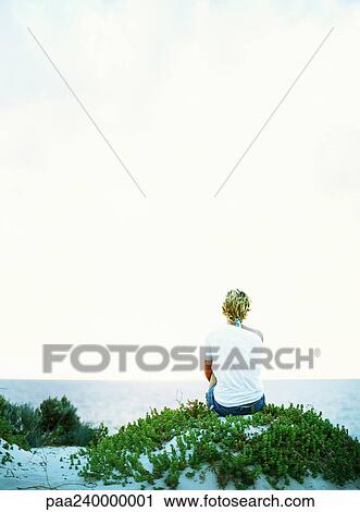 Woman looking out to sea, rear view View Large Photo Image Stock Image - Woman looking out to sea, rear view. Fotosearch