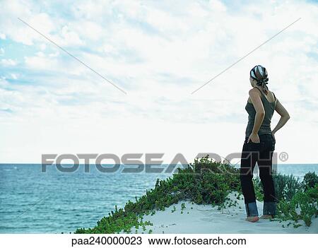 Woman looking out to sea, rear view View Large Photo Image Stock Image - Woman looking out to sea, rear view. Fotosearch