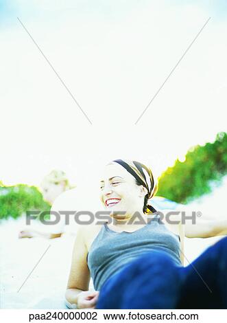 Woman lying on sand, smiling, adult lying in background View Large Photo Image Stock Image - Woman lying on sand, smiling, adult lying in background. Fotosearch