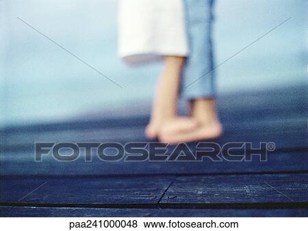 Child standing on other child's feet, low section, blurred View Large Photo Image Stock Photo - Child standing on other child's feet, low section, blurred. Fotosearch