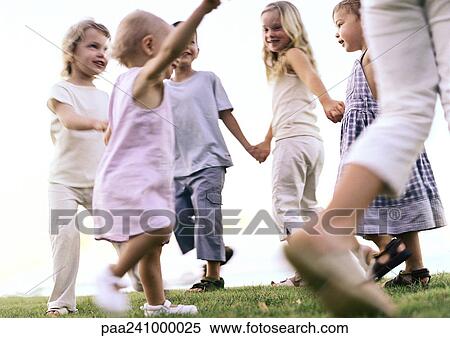 Children holding hands, walking in ring View Large Photo Image Stock Photography - Children holding hands, walking in ring. Fotosearch