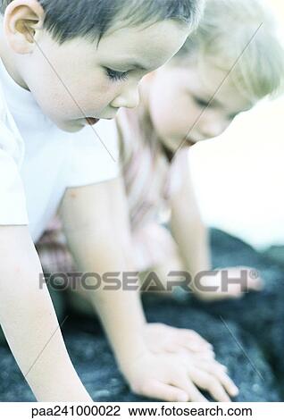 Stock Image - Children on rock, close-up. Fotosearch